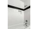 Contemporary bathroom showcasing white subway tile with sleek black accent stripe at 798 Saint Charles Ne Ave # 7, Atlanta, GA 30306