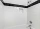 Modern bathroom features white subway tile, contrasting black accent stripe, and built-in niche at 798 Saint Charles Ne Ave # 7, Atlanta, GA 30306