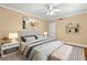 Inviting bedroom with ceiling fan, sleek hardwood floors, a patterned rug, and soft, neutral decor at 798 Saint Charles Ne Ave # 7, Atlanta, GA 30306