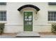 Charming covered doorway with green door surrounded by lush shrubbery, creating a welcoming entrance at 798 Saint Charles Ne Ave # 7, Atlanta, GA 30306