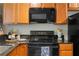 The kitchen features wooden cabinets, updated appliances, and granite countertops, making it modern and functional at 798 Saint Charles Ne Ave # 7, Atlanta, GA 30306