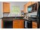 Modern kitchen boasts wood cabinets, dark countertops, and updated black appliances at 798 Saint Charles Ne Ave # 7, Atlanta, GA 30306