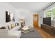 Bright living room features sleek hardwood floors, neutral decor and a large window with bright sunlight at 798 Saint Charles Ne Ave # 7, Atlanta, GA 30306