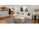 Bright living room with modern decor, including a plush white sofa and view to a well-equipped kitchen at 798 Saint Charles Ne Ave # 7, Atlanta, GA 30306