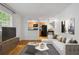 Open-concept living room showcases hardwood floors, contemporary furniture, and a seamless transition to the kitchen at 798 Saint Charles Ne Ave # 7, Atlanta, GA 30306