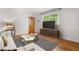 Bright living room with hardwood floors, neutral decor and large window providing ample natural light at 798 Saint Charles Ne Ave # 7, Atlanta, GA 30306