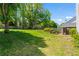 Spacious backyard featuring a lush lawn, mature trees, landscaping, and a fenced perimeter at 920 Pebblestone Ct, Alpharetta, GA 30009