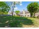 Expansive backyard with mature trees, lush green lawn, and a covered patio area for outdoor enjoyment at 920 Pebblestone Ct, Alpharetta, GA 30009