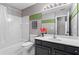 Bathroom with a tub, shower, and vanity with decorative accents, offering a comfortable design at 920 Pebblestone Ct, Alpharetta, GA 30009