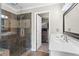 Bathroom features a separate shower, large sink, and a door to a walk-in closet with custom organizers at 920 Pebblestone Ct, Alpharetta, GA 30009