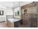 Bathroom features a separate shower, soaking tub, tiled surround, and large window providing great views at 920 Pebblestone Ct, Alpharetta, GA 30009