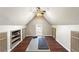Spacious bonus room with vaulted ceiling, wood floors, and built-in shelves for storage at 920 Pebblestone Ct, Alpharetta, GA 30009
