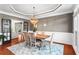 Formal dining room with elegant trim, wainscoting, and stylish light fixture at 920 Pebblestone Ct, Alpharetta, GA 30009