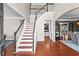 Elegant foyer with hardwood floors, staircase, and views into other living spaces at 920 Pebblestone Ct, Alpharetta, GA 30009