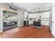 Bright kitchen with white cabinetry, stainless steel appliances, hardwood floors, and backyard patio access at 920 Pebblestone Ct, Alpharetta, GA 30009