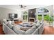 Open living room with fireplace and large windows at 920 Pebblestone Ct, Alpharetta, GA 30009