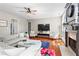 Cozy living room with fireplace and large TV at 920 Pebblestone Ct, Alpharetta, GA 30009