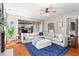 Bright living room featuring a large sectional sofa, hardwood floors, and seamless transition to the kitchen at 920 Pebblestone Ct, Alpharetta, GA 30009