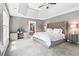 Elegant main bedroom with tray ceiling, plush carpeting, ample natural light, and a connected spa bathroom at 920 Pebblestone Ct, Alpharetta, GA 30009