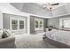 Spacious main bedroom with a tray ceiling, sitting area, and lots of natural light overlooking the backyard at 920 Pebblestone Ct, Alpharetta, GA 30009