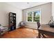 Cozy office space with a desk, shelving, and natural light from the window overlooking the yard at 920 Pebblestone Ct, Alpharetta, GA 30009