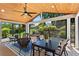 Relaxing screened-in porch featuring a wood ceiling, fan, and a beautiful view of the landscaped backyard at 920 Pebblestone Ct, Alpharetta, GA 30009