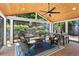 Inviting sunroom with wood ceiling, ceiling fan, brick flooring, and backyard views at 920 Pebblestone Ct, Alpharetta, GA 30009