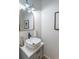 Powder room featuring a vessel sink, gold-framed mirror, and modern lighting fixtures at 1004 Spruce Creek Ln, Lawrenceville, GA 30045