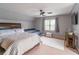Spacious bedroom with two beds, a ceiling fan, and large window, great for relaxing and unwinding at 1004 Spruce Creek Ln, Lawrenceville, GA 30045