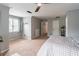 Bright bedroom with a ceiling fan, a cozy seating area, and plenty of closet space at 1004 Spruce Creek Ln, Lawrenceville, GA 30045