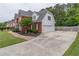 Side view of home showcasing brick and vinyl siding, plus long driveway at 1004 Spruce Creek Ln, Lawrenceville, GA 30045