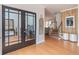 Welcoming foyer with wood floors, stairs, and glass paneled office doors at 1004 Spruce Creek Ln, Lawrenceville, GA 30045