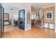 Welcoming foyer with wood floors, stairs, and glass paneled office doors at 1004 Spruce Creek Ln, Lawrenceville, GA 30045