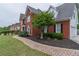 Beautiful brick home featuring manicured landscaping and a brick paver walkway at 1004 Spruce Creek Ln, Lawrenceville, GA 30045