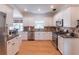 Bright kitchen with stainless steel appliances, granite countertops, and an adjacent dining area at 1004 Spruce Creek Ln, Lawrenceville, GA 30045