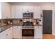 Well-appointed kitchen with stainless steel appliances, light cabinets, and granite countertops at 1004 Spruce Creek Ln, Lawrenceville, GA 30045