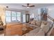 Bright living room featuring hardwood floors, a ceiling fan, and views of the outdoor living area at 1004 Spruce Creek Ln, Lawrenceville, GA 30045