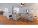 Open-concept living room with hardwood floors, comfortable seating, and access to other living areas at 1004 Spruce Creek Ln, Lawrenceville, GA 30045
