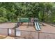Community playground features a slide, climbing structures, and fencing for safety at 1004 Spruce Creek Ln, Lawrenceville, GA 30045