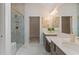 Bright bathroom with a large shower, double sink vanity, light tile flooring, and view into walk-in closet at 1307 Cedarcrest Blvd, Acworth, GA 30101