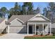 Charming single-story home featuring a covered front porch, gray siding, and an attached two-car garage at 1307 Cedarcrest Blvd, Acworth, GA 30101