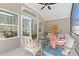 Cozy screened porch with comfortable seating, blue accents, and natural light streaming in from large windows at 1307 Cedarcrest Blvd, Acworth, GA 30101