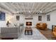 Finished basement with a cozy fireplace, exposed ceiling, and modern decor with hardwood floors at 250 Hembree Rd, Roswell, GA 30075