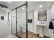 Modern bathroom featuring a glass shower, white tile walls, and black fixtures at 250 Hembree Rd, Roswell, GA 30075