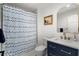 Cozy bathroom featuring navy blue vanity, gold accents, and shower with patterned curtain at 250 Hembree Rd, Roswell, GA 30075