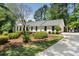 Traditional home with mature landscaping, a circular drive, and a private lot at 250 Hembree Rd, Roswell, GA 30075