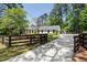 Charming home with a well-manicured lawn and a circular driveway at 250 Hembree Rd, Roswell, GA 30075