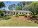 Charming brick home featuring a landscaped front yard and inviting front porch at 250 Hembree Rd, Roswell, GA 30075