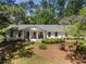 Charming brick home featuring a landscaped front yard and inviting front porch at 250 Hembree Rd, Roswell, GA 30075