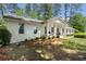 Beautifully landscaped home with a welcoming front porch and classic white brick exterior at 250 Hembree Rd, Roswell, GA 30075